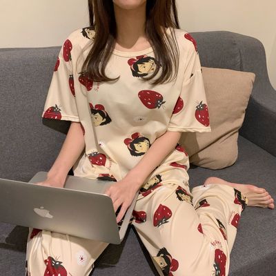 Pyjama deux pièces manches courtes pour femmes portée par une femme assise sur un capané dans une maison